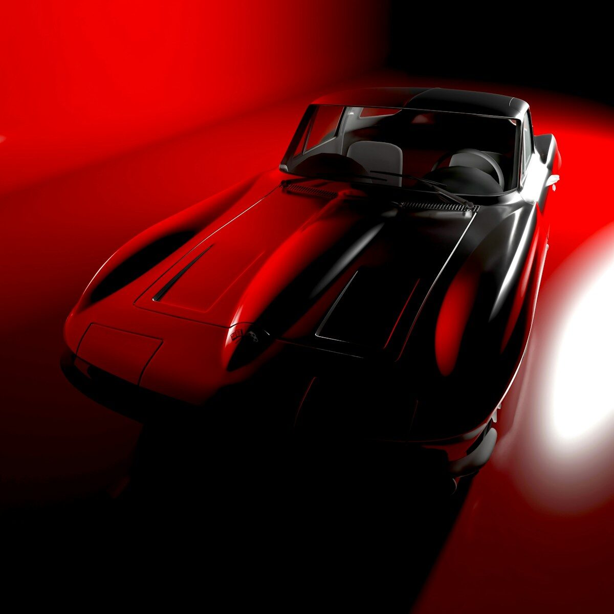 A sleek, dark sports car illuminated by red light