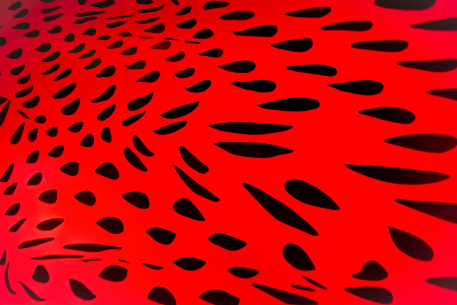 Abstract red background with black oval shapes